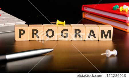 The concept word PROGRAM is collected of wooden cubes on a black background with stationery next to it. Loyalty Program Shopping concept The concept word PROGRAM is collected of wooden cubes on a black background with stationery next to it. Loyalty Program Shopping concept 131284918