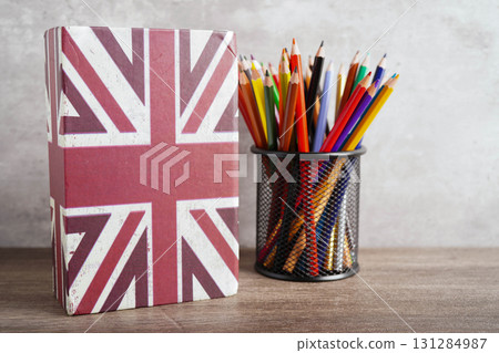 English book with graduate hat, learning and tutorial for foreigner. 131284987