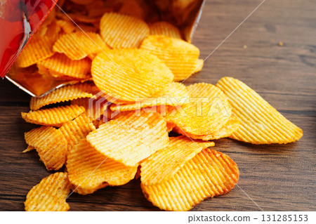 Potato chips , delicious BBQ seasoning spicy for crips, thin slice deep fried snack fast food. 131285153