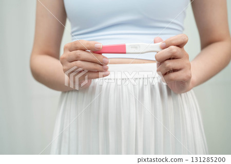 Asian holding pregnancy test for female of ovulation day, fetus, maternity, childbirth, birth control. 131285200