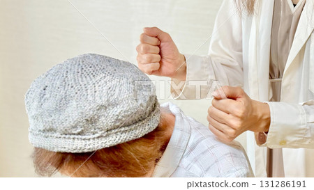 A woman's hand patting an elderly woman on the shoulder A woman's hand patting an elderly woman on the shoulder 131286191