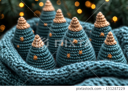 Neutral Palette. Crocheted bright Christmas trees on a winter background. Christmas atmosphere. Creative hobby. 131287229