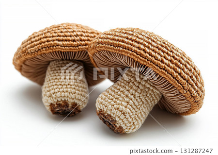 Cozy corner. Crocheted bright mushrooms on a white background. Autumn atmosphere. Creative hobby. 131287247