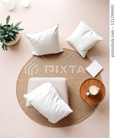 Cozy living space featuring a round woven rug, pillows, and a small wooden tray with a candle. 131288482
