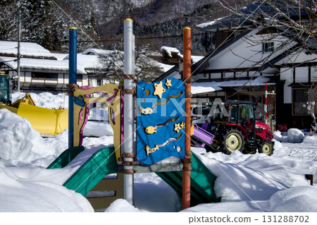 A snow-covered slide and a private tractor - a typical scene A snow-covered slide and a private tractor - a typical scene 131288702