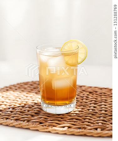 Refreshing iced tea in a tall glass with lemon slice on woven placemat Refreshing iced tea in a tall glass with lemon slice on woven placemat 131288769