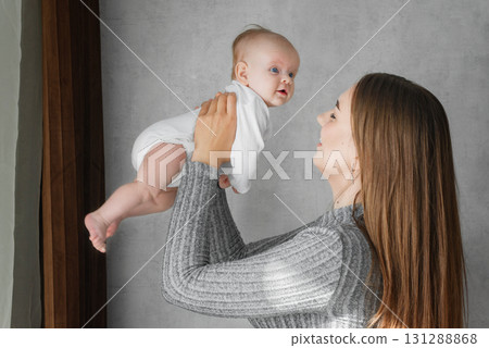 Mom holds a infant baby in her arms close-up. Mom holds a infant baby in her arms close-up. 131288868
