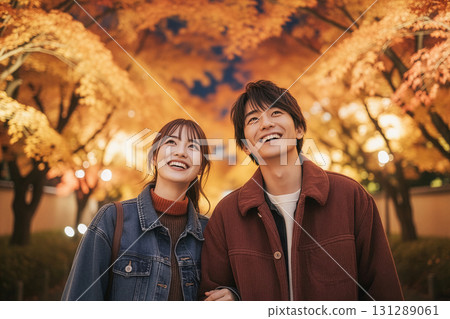 A couple looking at illuminated autumn leaves A couple looking at illuminated autumn leaves 131289061