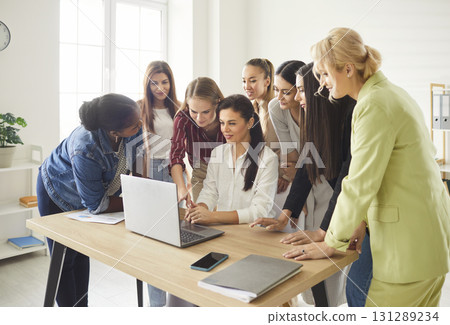 Team of young diverse business women using a laptop and working on an online project 131289234