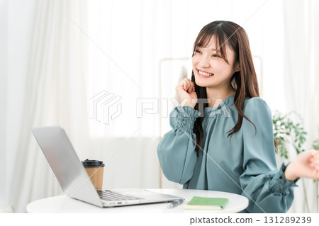 Young Asian businesswoman happy looking at computer at office/workplace 131289239