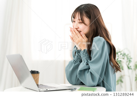 Young Asian businesswoman happy looking at computer at office/workplace 131289244
