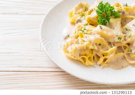 tortellini pasta with mushroom cream sauce and cheese 131290113