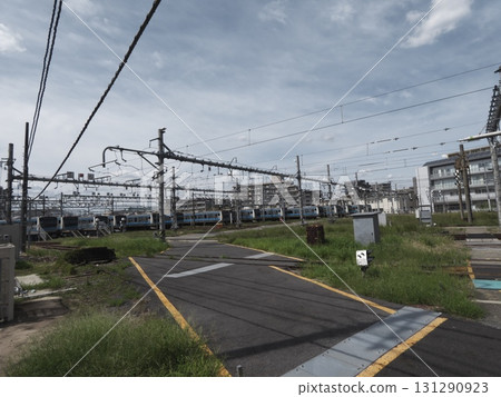 A railroad crossing in a railroad depot and many parked vehicles 131290923