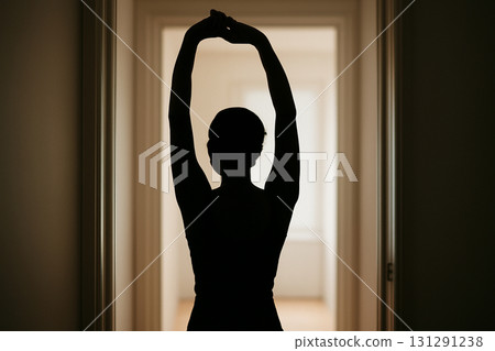 AI generated silhouette of a person stretching in a doorway, backlit by bright light. A calm and peaceful moment captured with clean and simple composition. Perfect for wellness and relaxation themes. 131291238