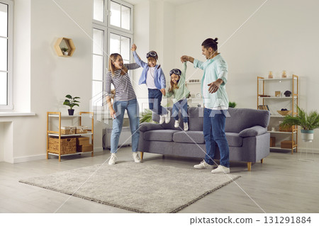 Happy family having fun with their kids in the living room at home. 131291884