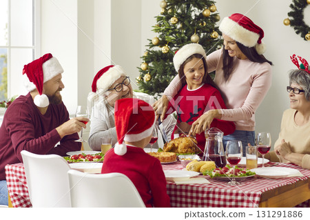 Portrait of happy big family sitting by Christmas table 131291886