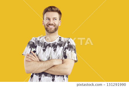 Portrait of happy young man standing with arms folded Portrait of happy young man standing with arms folded 131291990