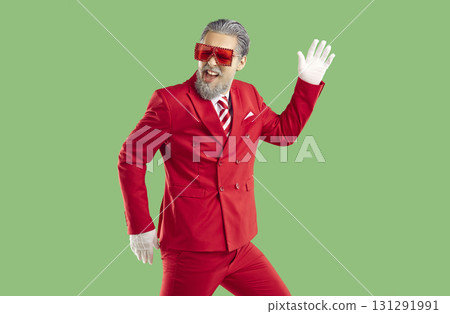 Santa Claus fooling around and dancing with his hand raised on isolated green background. Santa Claus fooling around and dancing with his hand raised on isolated green background. 131291991