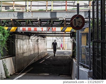 A sign indicating the height limit under the elevated railway overpass: ``Limited height 1.7M'' A sign indicating the height limit under the elevated railway overpass: ``Limited height 1.7M'' 131292077