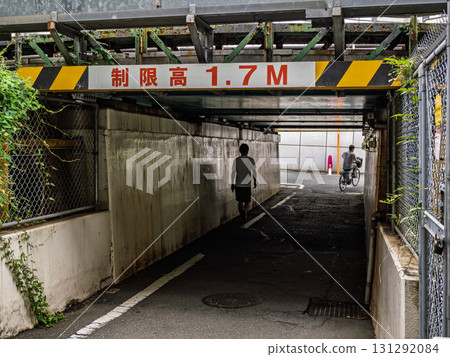 A sign indicating the height limit under the elevated railway overpass: ``Limited height 1.7M'' 131292084