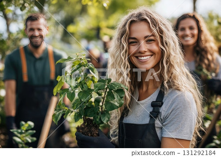 Happy people planting trees in garden 131292184