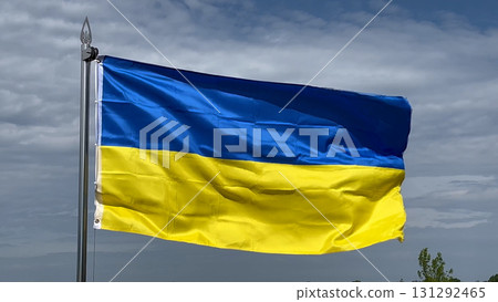 The large yellow and blue flag of Ukraine flies against the background of a sky The large yellow and blue flag of Ukraine flies against the background of a sky 131292465