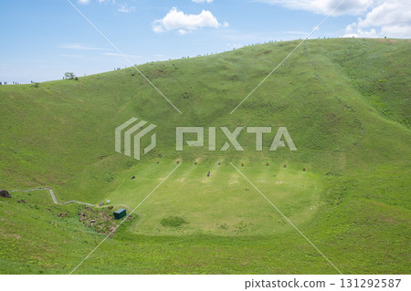 Omuro mountain in Ito, Shizuoka, Japan, Green grassy crater landscape under blue sky with scattered clouds 131292587