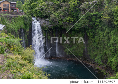 Otodome Falls at Fujinomiya, Shizuoka, Japan, Waterfall flowing into forest pool near building in lush green landscape Otodome Falls at Fujinomiya, Shizuoka, Japan, Waterfall flowing into forest pool near building in lush green landscape 131292697