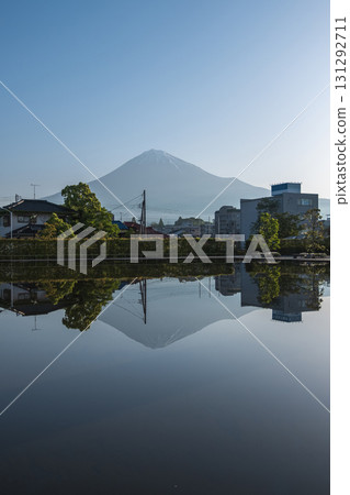 Mount Fuji reflected in water with buildings and trees in foreground at Fujinomiya, Shizuoka, Japan, Mount Fuji reflected in water with buildings and trees in foreground at Fujinomiya, Shizuoka, Japan, 131292711