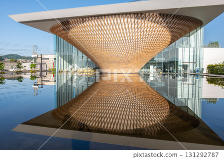 Mt. Fuji World Heritage Centre at Fujinomiya, Shizuoka, Japan, Modern architectural wooden canopy reflected in water at contemporary building exterior 131292787