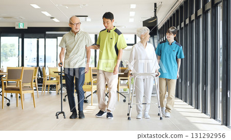 Asian caregiver supporting elderly people walking Asian caregiver supporting elderly people walking 131292956