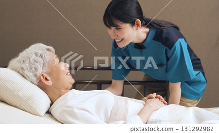Asian caregiver talking to elderly person Asian caregiver talking to elderly person 131292982