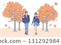Male and female students walking along a tree-lined path in autumn 131292984
