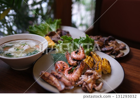 Grilled Seafood Feast on Outdoor Barbecue with Shellfish and Vegetables 131293032