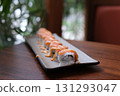A beautifully arranged platter of maki sushi rolls, including a variety of flavors and colors served elegantly. 131293047