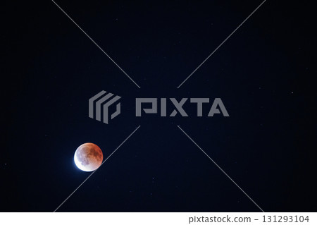 Blood moon glowing during lunar eclipse in a starry night sky, mystical celestial scene with cosmic atmosphere Blood moon glowing during lunar eclipse in a starry night sky, mystical celestial scene with cosmic atmosphere 131293104