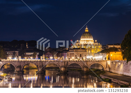 Night view of St. Peter's Basilica in Vatican City with the illuminated Ponte Sant'Angelo bridge reflected in the Tiber River in Rome Night view of St. Peter's Basilica in Vatican City with the illuminated Ponte Sant'Angelo bridge reflected in the Tiber River in Rome 131293238