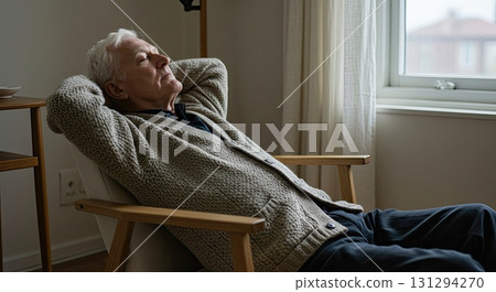 Pensive senior man resting in chair, deep pensive mood reflecting on life 131294270