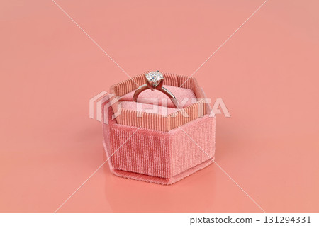 A engagement diamond ring is in a pink velvet jewelry box A engagement diamond ring is in a pink velvet jewelry box 131294331