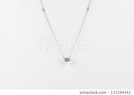 A necklace with a heart shaped diamond pendant 131294341