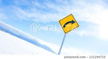 A simple landscape of the blue sky and right curve sign in Hokkaido in winter 131294710