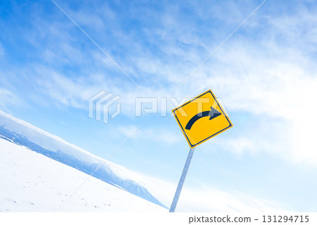A simple landscape of the blue sky and right curve sign in Hokkaido in winter 131294715