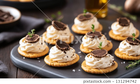 Sophisticated food scene with mushroom mousse crackers, truffle oil accents, and textured styling, perfect for editorial content, upscale events, and gourmet culinary branding. 131294742