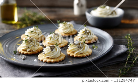 Elegant mushroom and truffle oil canapes on ceramic plate, surrounded by moody tones and refined garnishes, ideal for luxury dining visuals and high-end appetizer themes. 131294747