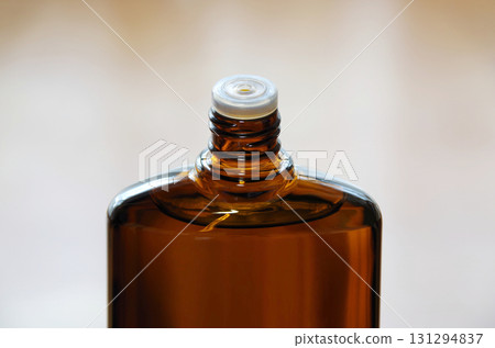 A bottle of hair growth product with the screw cap open 131294837