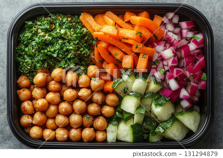 Plant based lunch box with hummus, roasted chickpeas, fresh veggie sticks and whole wheat pita bread on. 131294879