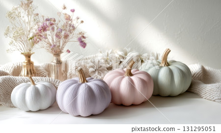 Blush pink and mint pumpkins styled with soft fabrics for modern spooky decor. 131295051