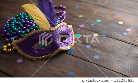 Purple masquerade mask with feathers and colorful beads for Mardi Gras celebration 131295623