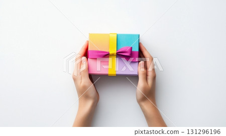 Hands unboxing a mystery toy with close-up action on white background. Great for e-commerce or toy ads. Hands unboxing a mystery toy with close-up action on white background. Great for e-commerce or toy ads. 131296196