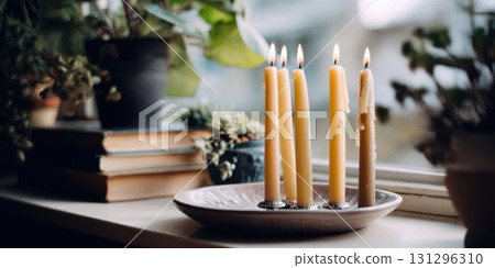 Interior styling focused on mindful ritual with candle plate, warm wax drips, and bohemian details 131296310